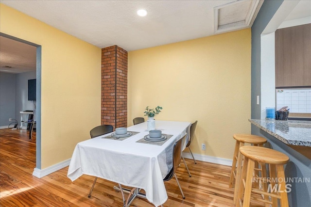 dining room with light wood-style flooring and baseboards