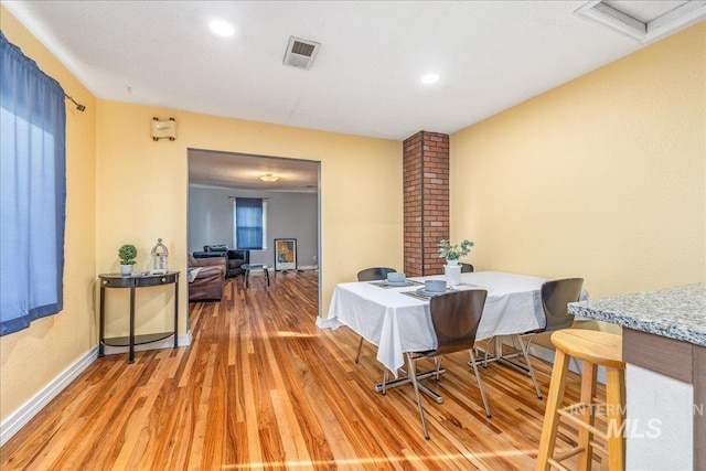 dining space with light wood-style flooring, baseboards, and recessed lighting