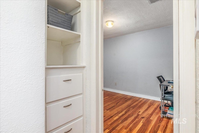 spacious closet with wood finished floors