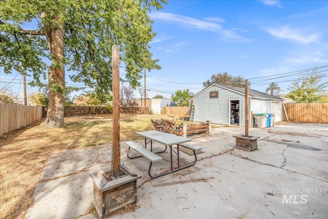 view of patio / terrace featuring a fenced backyard and an outbuilding