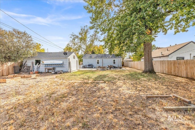 fenced backyard with an outdoor structure