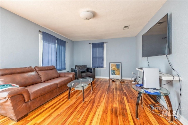 living area with wood finished floors and baseboards