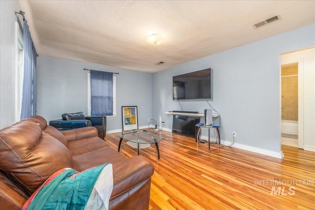 living room with wood finished floors and baseboards