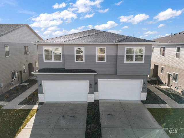 view of front of house featuring brick siding, an attached garage, and concrete driveway