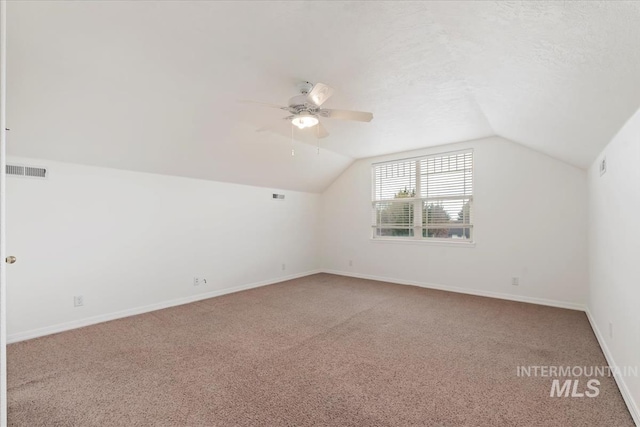 bonus room with baseboards, vaulted ceiling, visible vents, and carpet floors