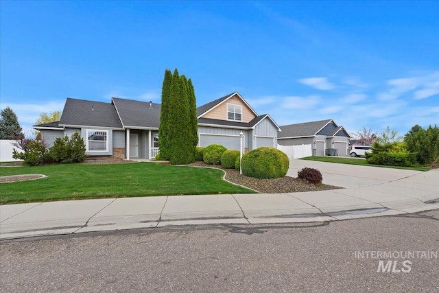 view of front of home featuring a front yard, an attached garage, board and batten siding, and driveway