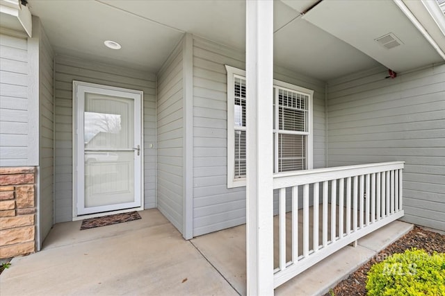 view of exterior entry with covered porch