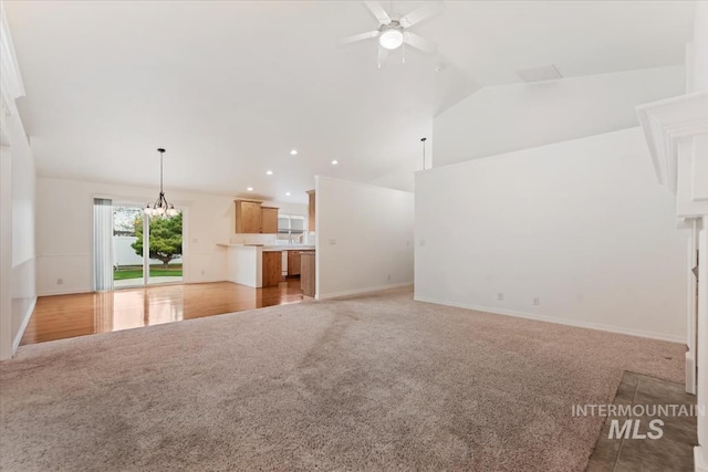 unfurnished living room featuring baseboards, recessed lighting, ceiling fan, high vaulted ceiling, and light colored carpet