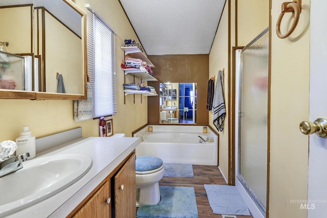 bathroom featuring a garden tub, vanity, wood finished floors, and a stall shower