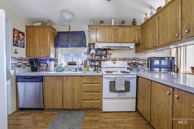 kitchen featuring wallpapered walls, dark wood finished floors, exhaust hood, stainless steel dishwasher, and white electric range oven
