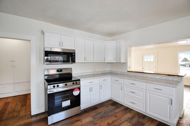 kitchen with stainless steel appliances, dark wood-type flooring, white cabinets, and light countertops