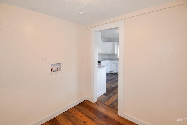 hallway with hardwood / wood-style flooring and baseboards