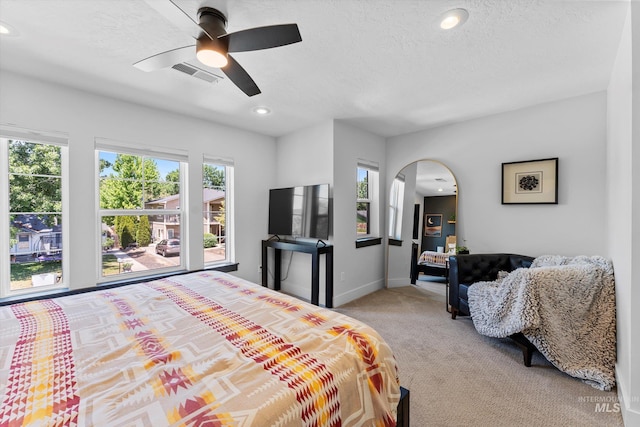 918 N 31st St, Boise, ID 83702 - bedroom featuring light colored carpet, arched walkways, recessed lighting, ceiling fan, and a textured ceiling