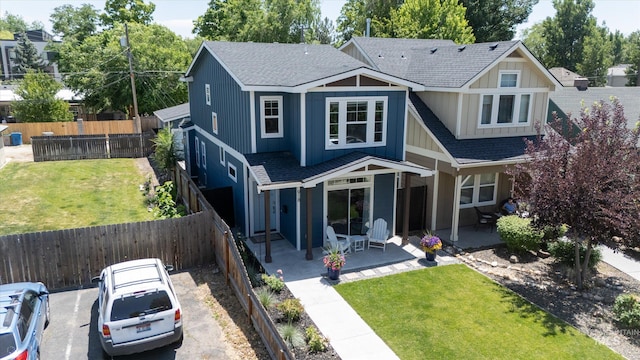 918 N 31st St, Boise, ID 83702 - back of property featuring a shingled roof, a fenced backyard, and a patio area