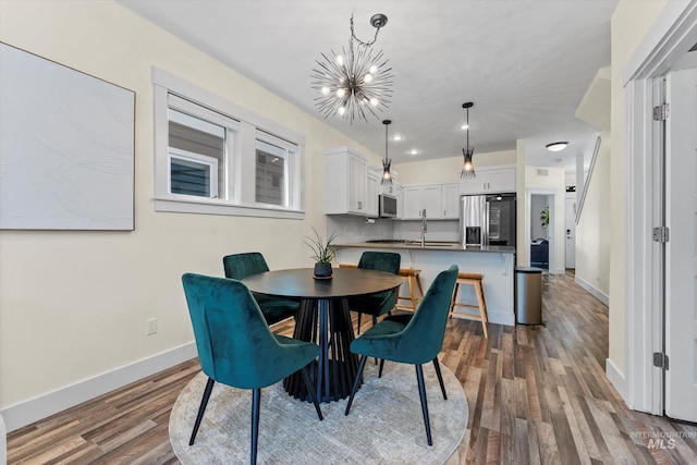 918 N 31st St, Boise, ID 83702 - dining area featuring a chandelier and dark wood-style floors