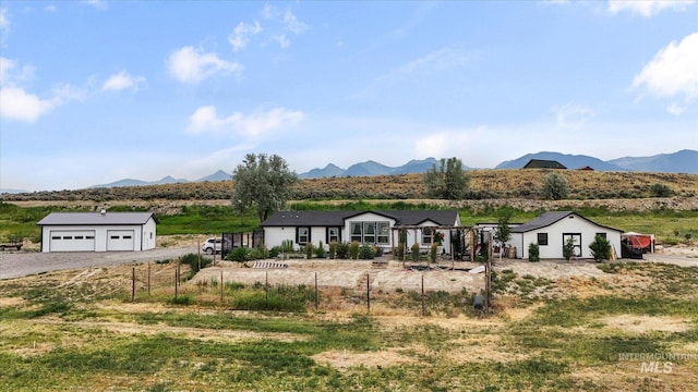 view of front of property with a mountain view and a rural view