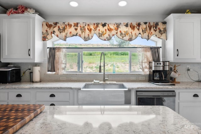 kitchen featuring plenty of natural light, sink, decorative backsplash, and stainless steel dishwasher