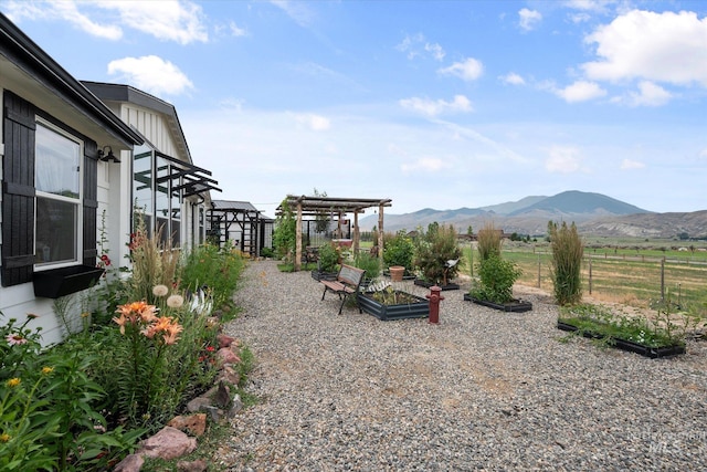 view of yard featuring a pergola and a mountain view