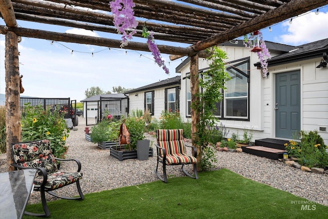 view of patio / terrace featuring a pergola and an outbuilding