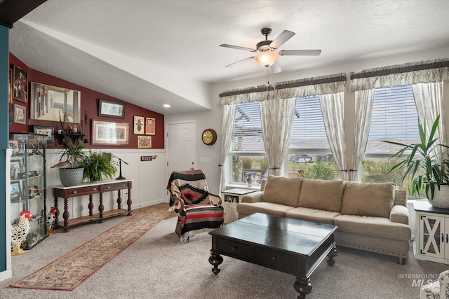 living room featuring carpet, ceiling fan, and lofted ceiling