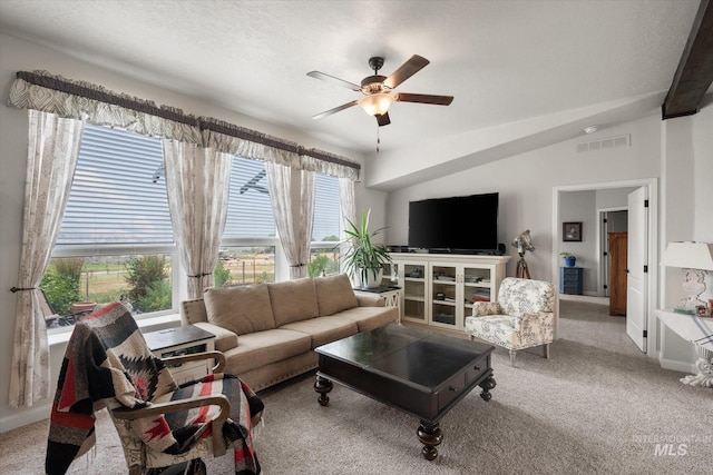 living room featuring vaulted ceiling, ceiling fan, and carpet flooring