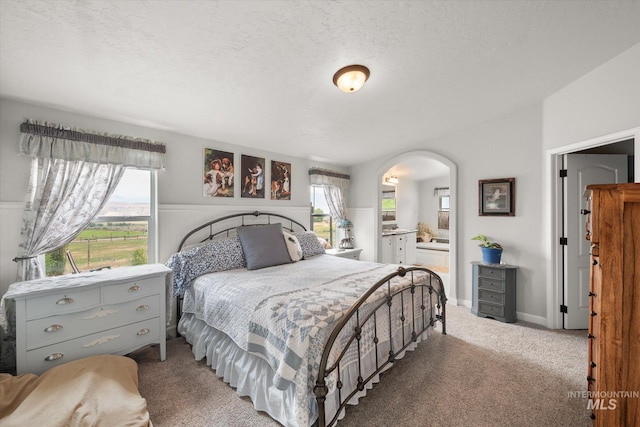 carpeted bedroom featuring a textured ceiling