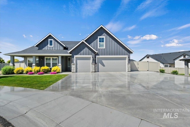 13958 Levendi Ct, Caldwell, ID 83607 - view of front facade with board and batten siding, driveway, a garage, and stone siding
