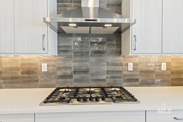 13958 Levendi Ct, Caldwell, ID 83607 - kitchen with wall chimney exhaust hood, stainless steel gas cooktop, white cabinetry, and tasteful backsplash