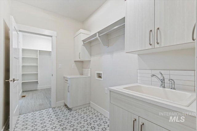 13958 Levendi Ct, Caldwell, ID 83607 - laundry room featuring light flooring, washer hookup, cabinet space, and baseboards