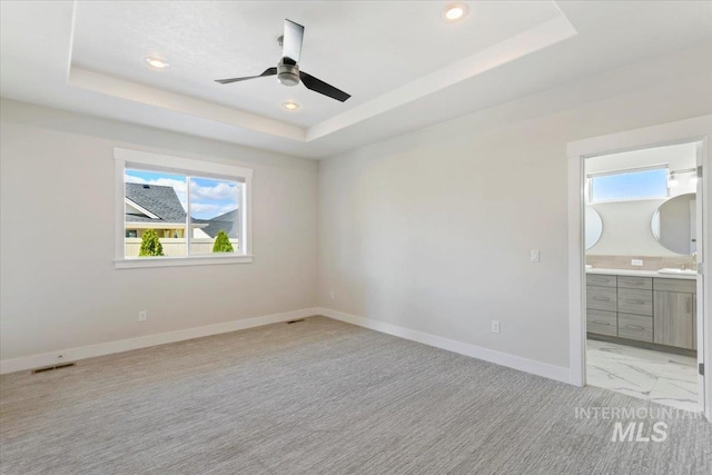 13958 Levendi Ct, Caldwell, ID 83607 - unfurnished bedroom with a raised ceiling, multiple windows, baseboards, light carpet, and recessed lighting
