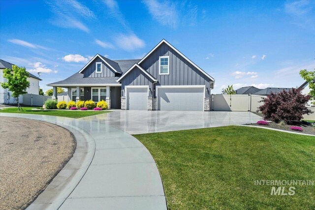 13958 Levendi Ct, Caldwell, ID 83607 - craftsman-style home featuring board and batten siding, concrete driveway, an attached garage, stone siding, and a gate