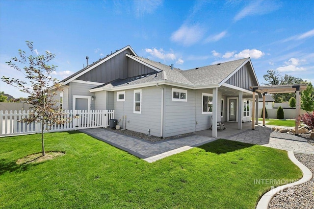13958 Levendi Ct, Caldwell, ID 83607 - rear view of house with board and batten siding, a patio area, and roof with shingles