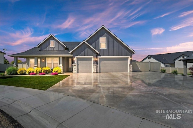 13958 Levendi Ct, Caldwell, ID 83607 - view of front of property featuring board and batten siding, concrete driveway, a garage, and stone siding