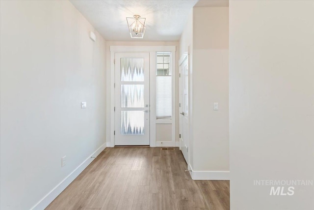 13958 Levendi Ct, Caldwell, ID 83607 - entryway with wood finished floors, a chandelier, and baseboards
