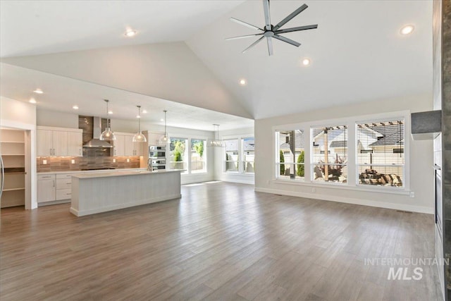 13958 Levendi Ct, Caldwell, ID 83607 - unfurnished living room featuring recessed lighting, high vaulted ceiling, ceiling fan, light wood-type flooring, and baseboards