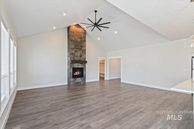 13958 Levendi Ct, Caldwell, ID 83607 - unfurnished living room featuring a fireplace, high vaulted ceiling, wood finished floors, ceiling fan, and baseboards