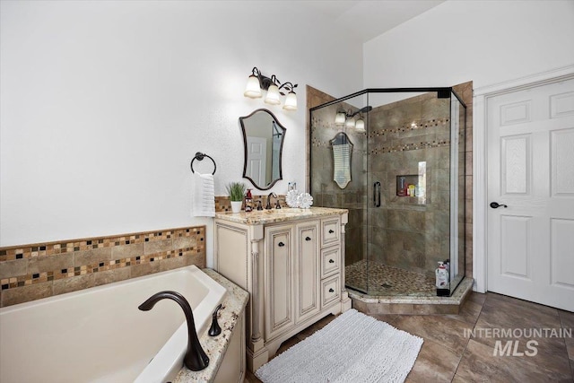 bathroom with vanity, a bath, and a shower stall