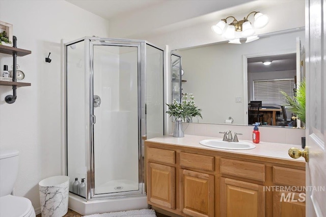 full bath with a shower stall, toilet, and vanity