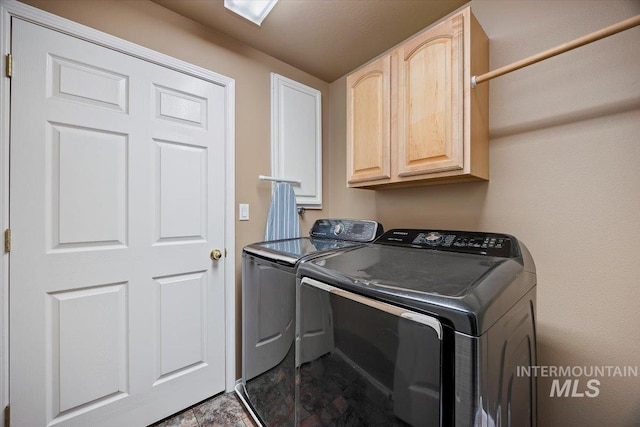 clothes washing area with cabinet space and washing machine and clothes dryer