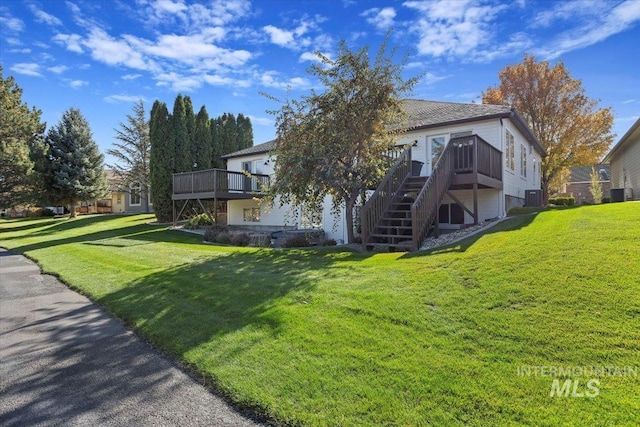 exterior space with stairway, a wooden deck, and central air condition unit