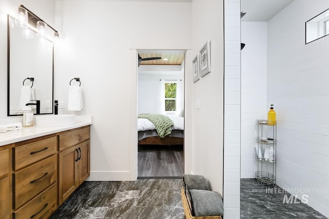 bathroom featuring a shower and vanity