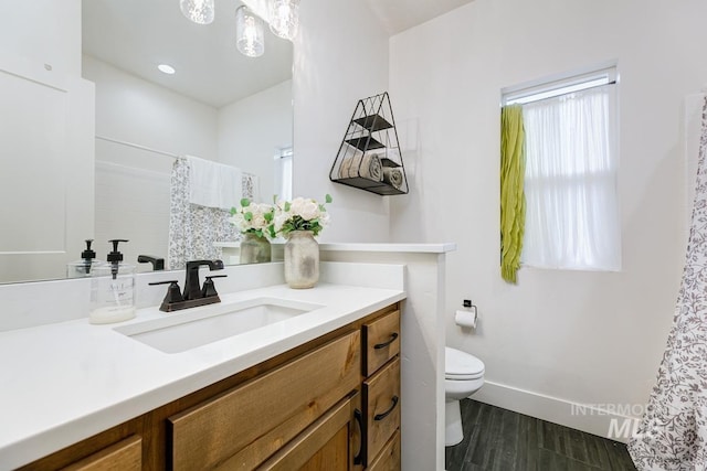 bathroom featuring hardwood / wood-style floors, vanity, and toilet