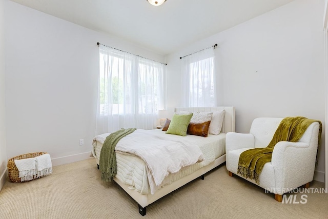 bedroom featuring carpet and multiple windows