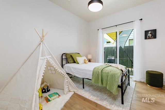 bedroom with hardwood / wood-style flooring and access to exterior