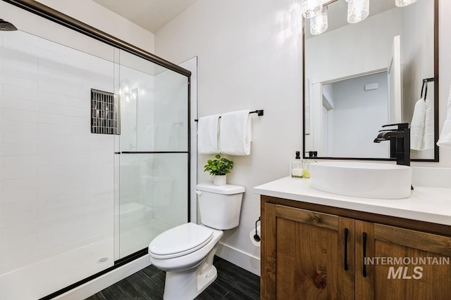 bathroom featuring vanity, toilet, wood-type flooring, and walk in shower