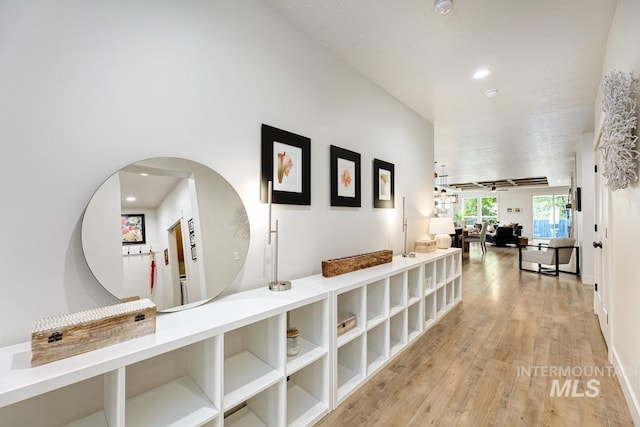 hallway with light hardwood / wood-style floors