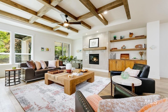 living room featuring beam ceiling, light hardwood / wood-style flooring, and coffered ceiling