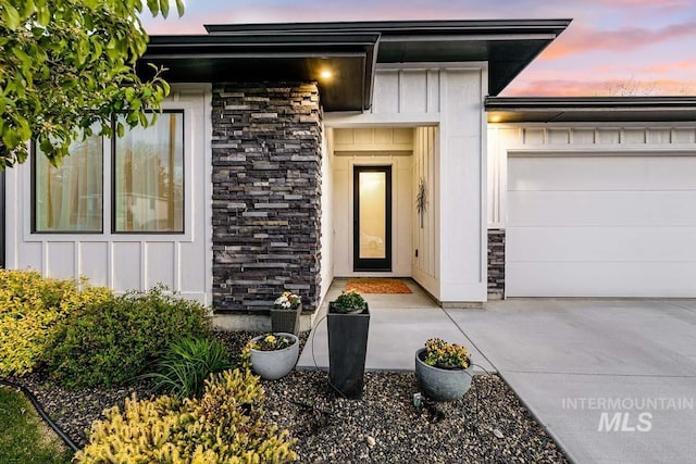 exterior entry at dusk with a garage