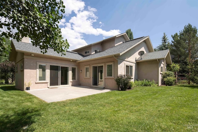 205 Shaun Ln, Hailey, ID 83333 - rear view of property with stucco siding, a patio, and a lawn