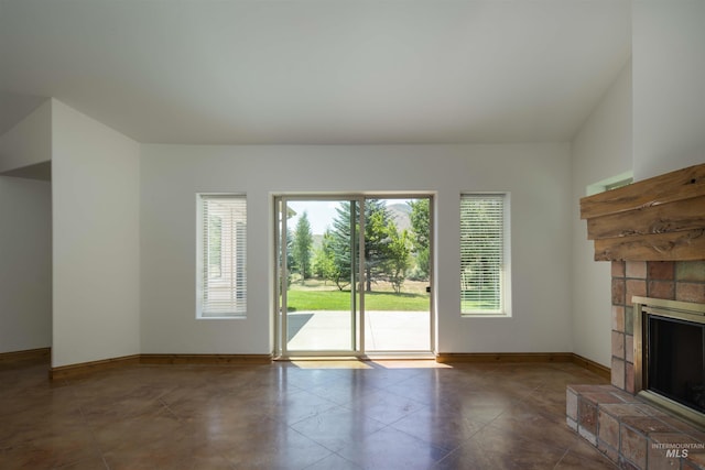 205 Shaun Ln, Hailey, ID 83333 - unfurnished living room featuring a fireplace, baseboards, and tile patterned flooring